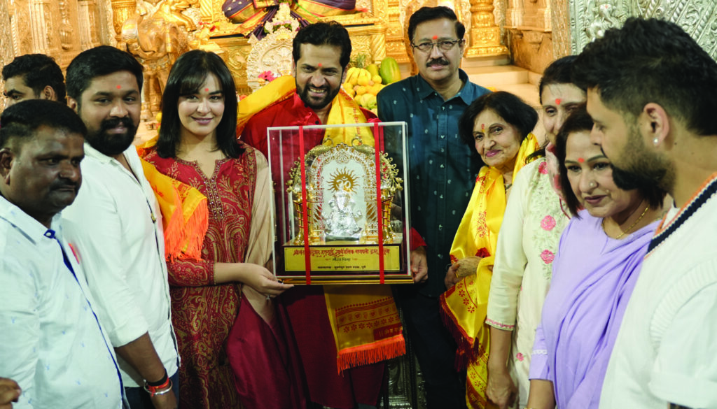 First Kinetic DX electric scooter receiving blessings at Shrimant Dagdusheth Ganpati Temple in Pune
