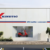 Kinetic EV dealership celebrating 100 vehicle deliveries at Surat and Pune, showcasing electric scooter showroom and sustainable mobility in India.